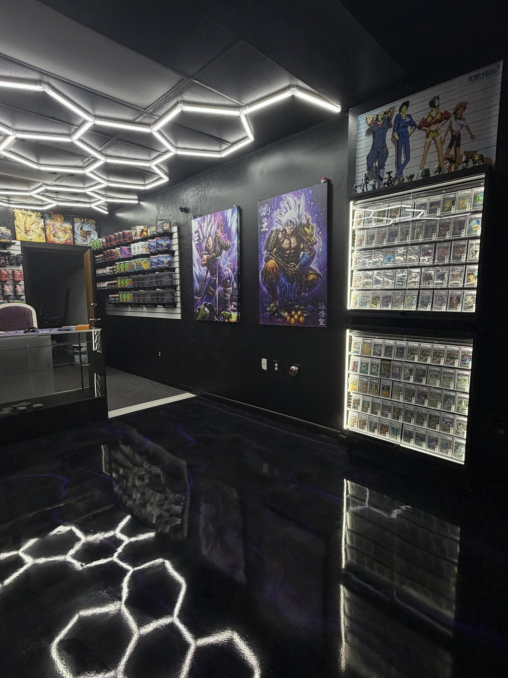 Wall display cases of Pokémon singles and slabs at Deadweight TCG